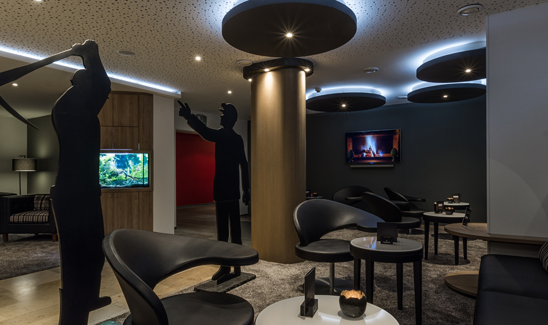 Stylish lounge with seating areas, warm lighting, and locally inspired design details.